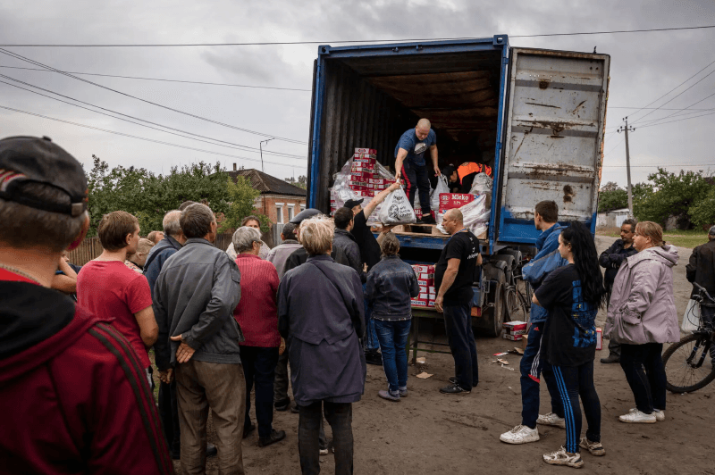 Handing out humanitarian aid Oct. 2 on the outskirts of Izium, a city recently retaken by Ukrainian forces.